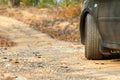 Back side of car parking on the Dirt road /mountain road/country road in Forest in Thailand. Royalty Free Stock Photo