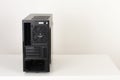 Back side of empty midi tower computer case on white table Royalty Free Stock Photo