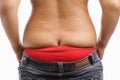 Back side of fat woman trying to wear tight jeans Royalty Free Stock Photo