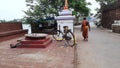 Back side of a Hindu priest walking through the road.