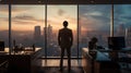 Back side of a hopeful man standing in an office area in front of window