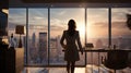 Back side of a hopeful woman standing in an office area in front of window