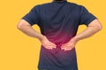 Back side of man suffering from backache isolated on orange background background Royalty Free Stock Photo