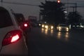 Back side of pick up car gray color on the asphalt road.Cars on the road in traffic junction at night with red light signal. Royalty Free Stock Photo