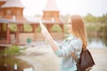 Back side of traveler girl searching right direction on map, orange sunset light, traveling along Europe Royalty Free Stock Photo