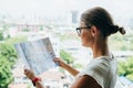 Back side of traveler girl searching right direction on map, traveling along Asia Royalty Free Stock Photo