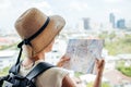 Back side of traveler girl searching right direction on map, traveling along Asia Royalty Free Stock Photo