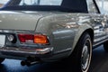 Back and side view of grey retro cabriolet car with close up of right chrome backlight and exhaust pipe, wheel arch Royalty Free Stock Photo