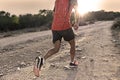 Sport man with ripped athletic and muscular legs running uphill off road in jogging training workout Royalty Free Stock Photo