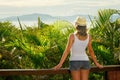 Back side view on wonderful young woman in hat on terrace Royalty Free Stock Photo