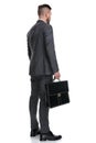 Back side view of a young businessman holding  suitcase Royalty Free Stock Photo