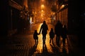 Back of silhouettes family walking in night city