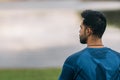 Back of a sportive man facing a lake in a park Royalty Free Stock Photo