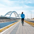 Back of sportswoman running on a pavement ooutdoors Royalty Free Stock Photo