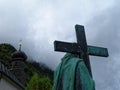 Jesus Christ stone statue with cross carried on shoulders Good Friday scene