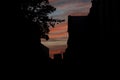 Back street passage building silhouette frame dangerous alley in dark shadow of evening dusk with cloudscape backgrounds