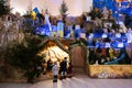 Back of three children looking in Christmas nativity crib scene in church