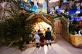 Back of three children looking in Christmas nativity crib scene in church