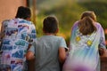 Back of three children looking down from balcony or terrace Royalty Free Stock Photo