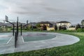 Back to back half basketball courts with homes and towering mountain background Royalty Free Stock Photo