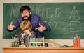 Back to class is cool. using microscope in lab. Back to school. teacher man with little boy. school lab equipment Royalty Free Stock Photo