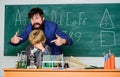 Back to class is cool. using microscope in lab. Back to school. teacher man with little boy. school lab equipment Royalty Free Stock Photo