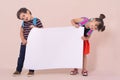 Back to school - advertisements. School Kids with backpacks holding white blank or white card. Royalty Free Stock Photo