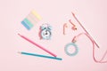 Back to school - alarm clock and pencils, headphones and stationery on pink background, girly set Royalty Free Stock Photo