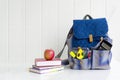 Back to school. Apple, pile of books and backpack on the desk at the school. Royalty Free Stock Photo