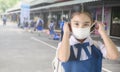 Back to school. asian child girl wearing face mask with backpack going to school. Covid-19 coronavirus pandemic. New normal Royalty Free Stock Photo