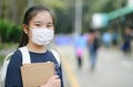 Back to school. asian child girl wearing face mask with backpack going to school .Covid-19 coronavirus pandemic.New normal