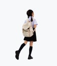 Back to school. Asian junior school student in british international uniform carrying backpack walking Royalty Free Stock Photo