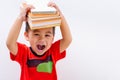 Back to school, Asian student boy kid stack book balanced on head