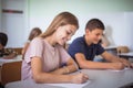 Teenagers students sitting in the classroom. Focus is on foreground