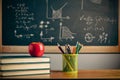 Back to school background with books, pencils and apple over chalkboard and wooden table Royalty Free Stock Photo