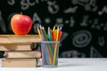 Back to school background with books, pencils and apple on white table Royalty Free Stock Photo