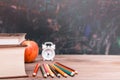 Back to school background with books, pencils, clock and apple on a wooden table Royalty Free Stock Photo