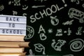 Back to school background with books, pencils and globe on white table on a green blackboard background Royalty Free Stock Photo