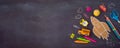 Back to school background with cardboard rocket and school supplies over chalkboard. Top view from above Royalty Free Stock Photo