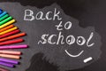 Back to school background with colorful felt tip pens and title Back to school written by white chalk Royalty Free Stock Photo