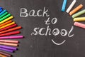 Back to school background with colorful felt tip pens and title Back to school written by white chalk Royalty Free Stock Photo