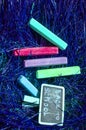 Back to school background with colorful neon colored crayons, on purple glowing background. Flat position, top view, copy space. Royalty Free Stock Photo