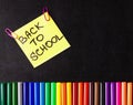 Back to school background with a lot of colorful felt-tip pens and colorful pencils, titles Back to school on the yellow Royalty Free Stock Photo