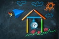 Back to school background with school made from pencils, alarm clock, paper plane, and chalk drawing Royalty Free Stock Photo