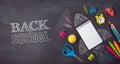 Back to school background with notebook, rocket sketch and school supplies over chalkboard. Top view from above Royalty Free Stock Photo