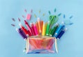 Back to school background with opened trendy neon pencil case with variety of school supplies in rainbow colors on Royalty Free Stock Photo