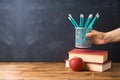 Back to school background with pencils, apple, books and alarm clock over chalkboard Royalty Free Stock Photo