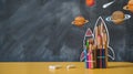 Back to school background with rocket made from pencils on chalkboard. Alarm clock, atom, chemistry. Piece of chalk Royalty Free Stock Photo