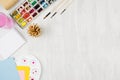 Back to school background - stationery for creativity - watercolor paints, palette, brushes, colored pencils on white wood table, Royalty Free Stock Photo