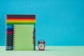 Back to school background. Time to study. Beginning of new school year. Copy-books and red alarm clock, copy space Royalty Free Stock Photo
